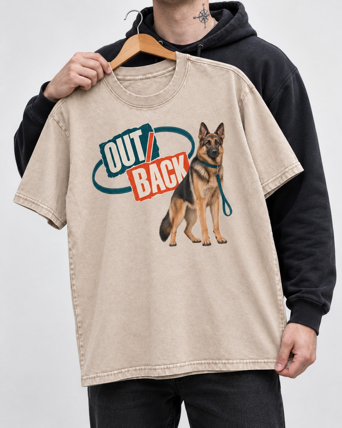 Out Back Leash German Shepherd Dog Graphic Washed Tee in Apricot, held up on a hanger