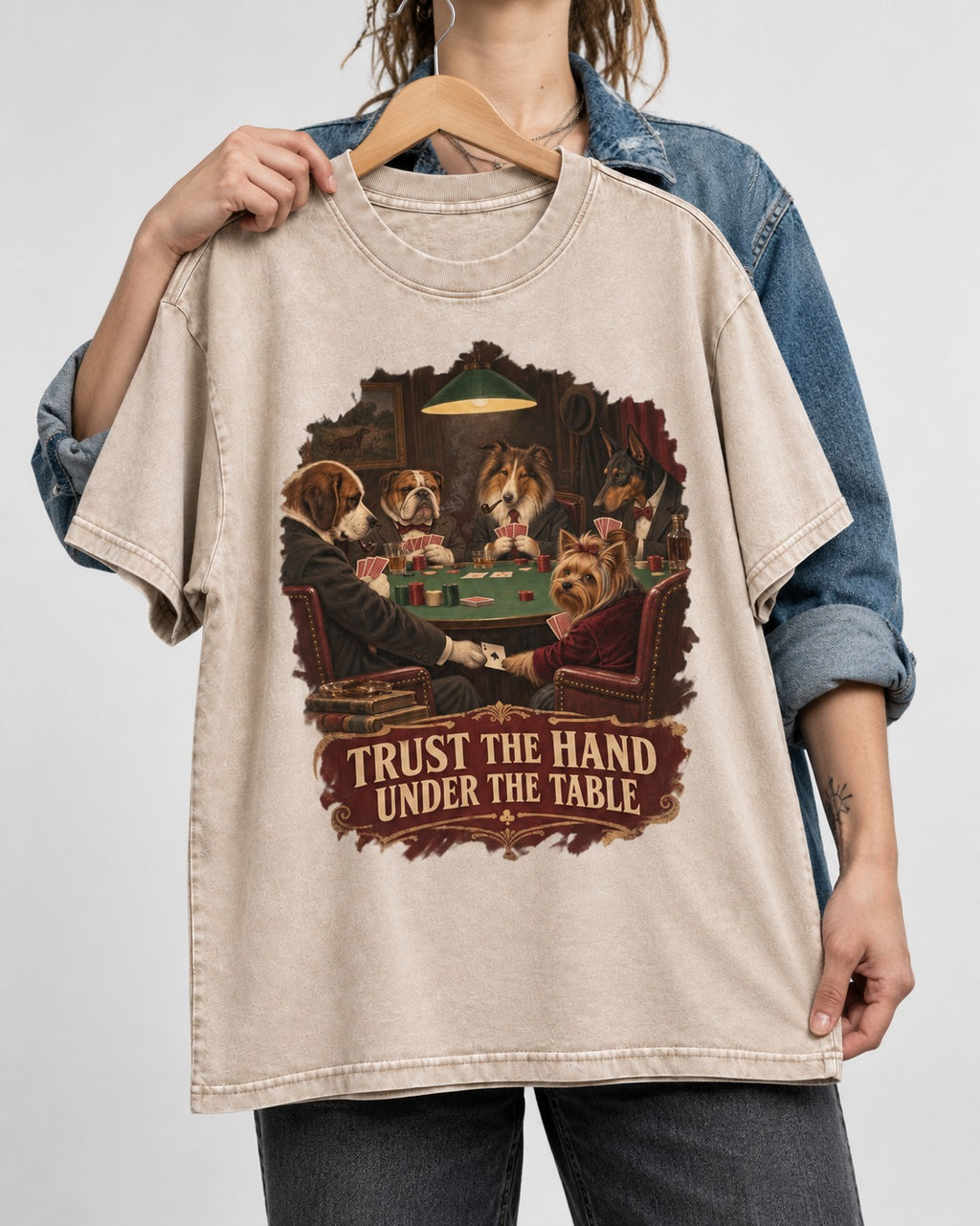 Yorkshire Terrier Trust the Hand Under the Table Poker Dogs Graphic Washed Tee in Apricot, held up on a hanger