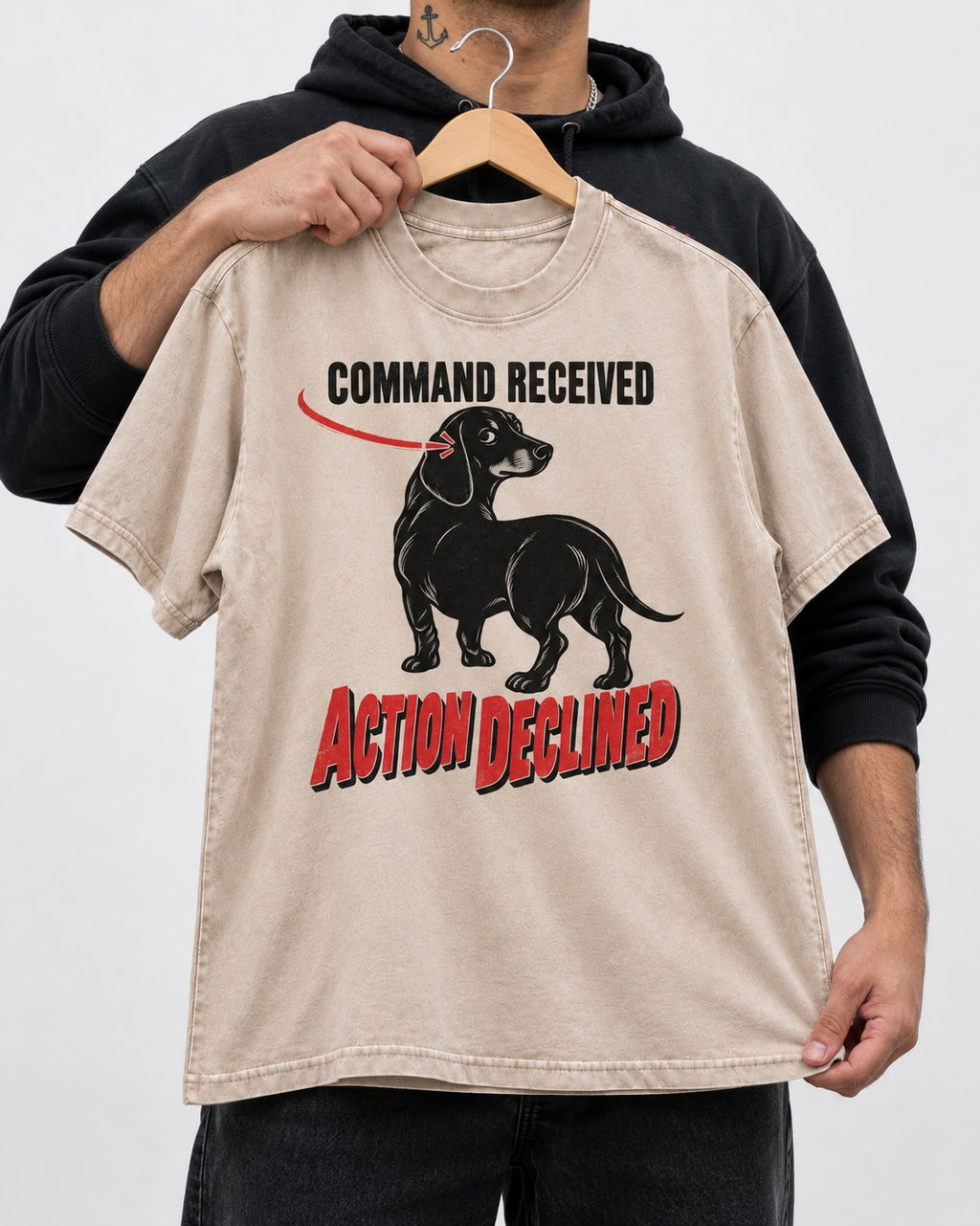 Dachshund Action Declined Washed Tee in Apricot, held up on a hanger