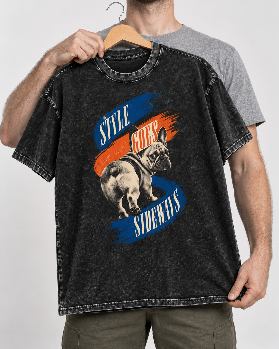Frenchie Style Goes Sideways Graphic Washed Tee in Black, held up on a hanger