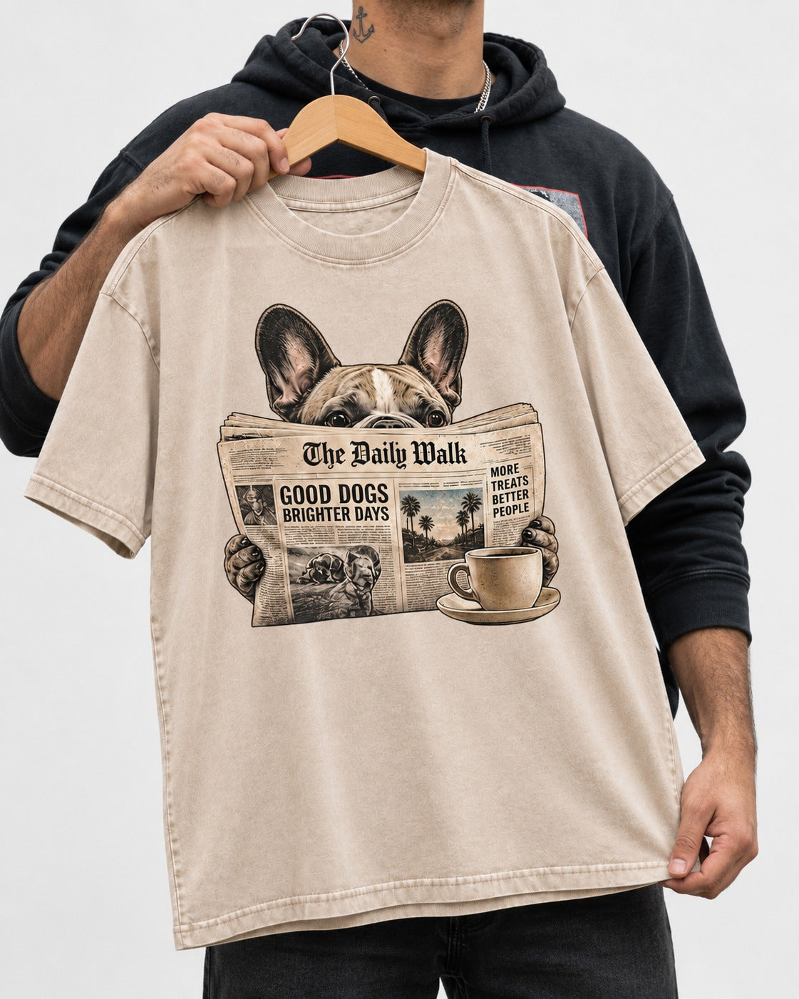Frenchie Good Dogs Brighter Days Newspaper Graphic Washed Tee in Apricot, held up on a hanger