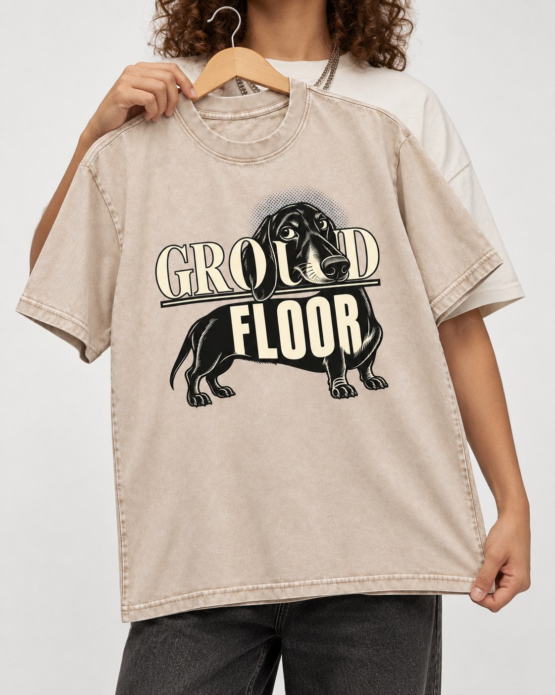 Ground Floor Dachshund Washed Tee in Apricot, held up on a hanger