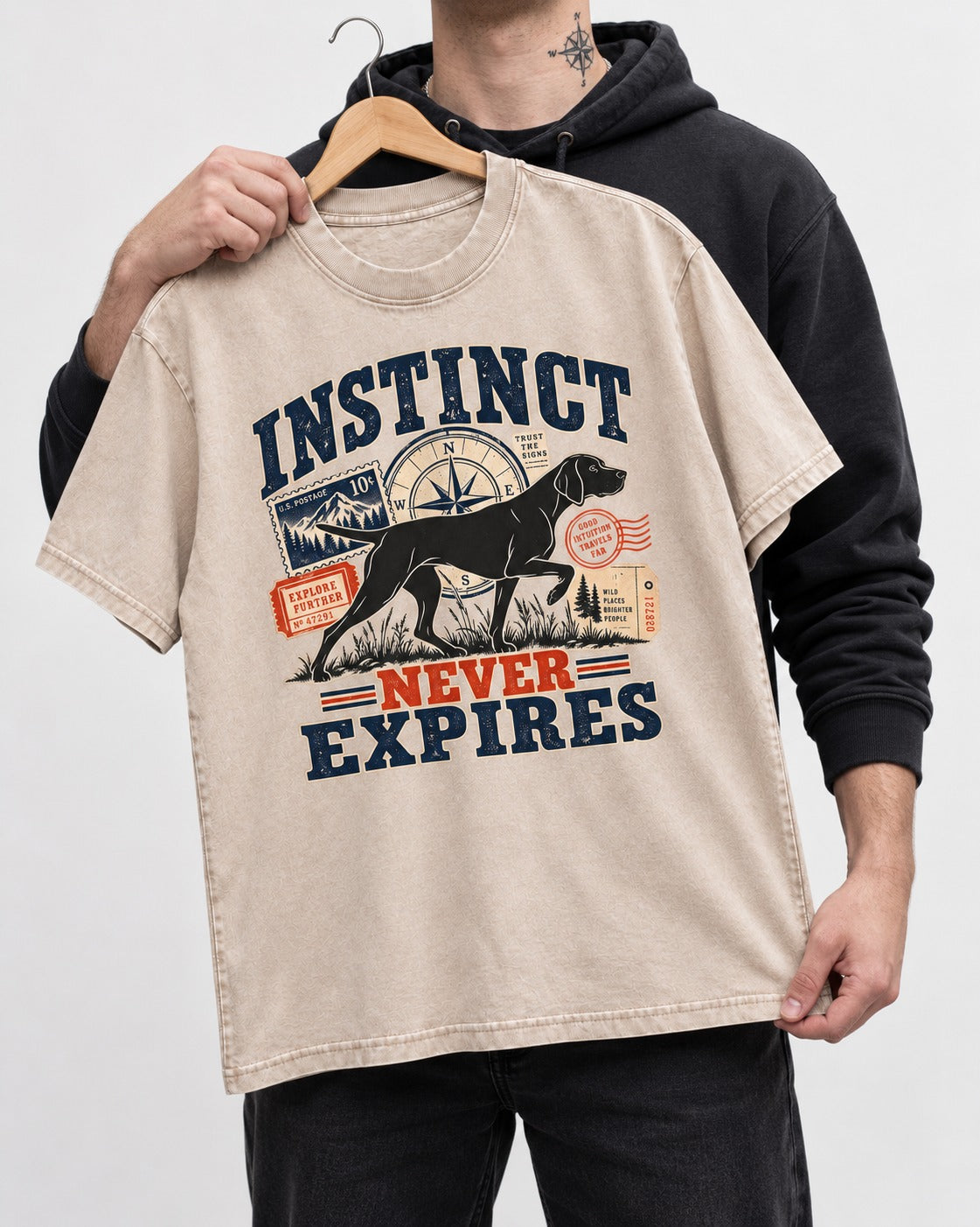 German Shorthaired Pointer Instinct Never Expires Washed Tee in Apricot, held up on a hanger
