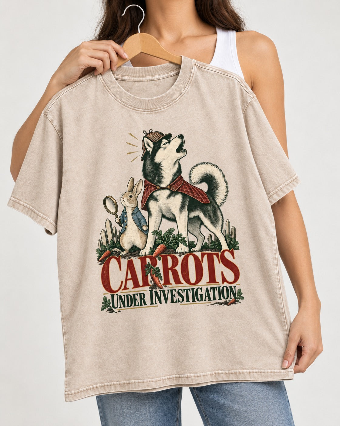 Carrots Under Husky Investigation Washed Tee in Apricot, held up on a hanger