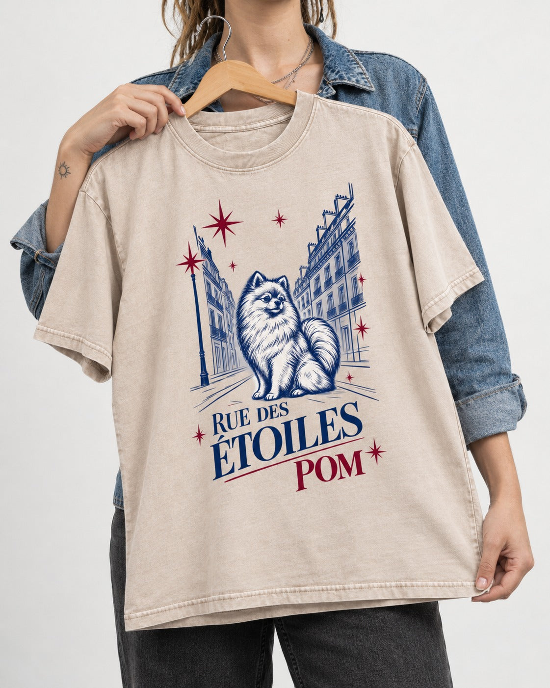 Pomeranian Among the Stars Washed Tee in Apricot, held up on a hanger