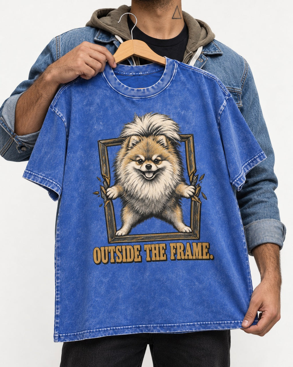 Pomeranian Outside the Frame Breakthrough Graphic Washed Tee in Royal Blue, held up on a hanger