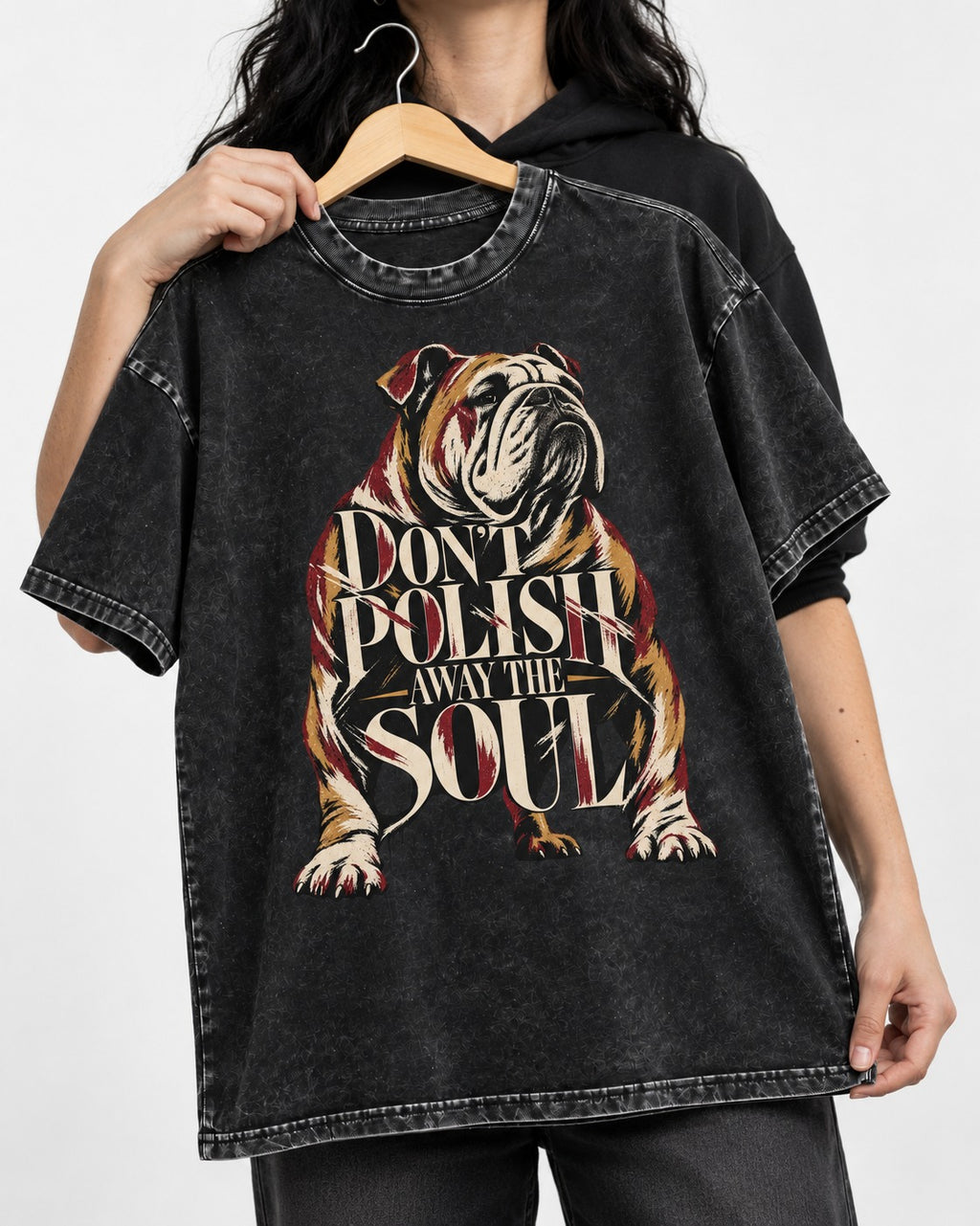 English Bulldog Don't Polish Away the Soul Typography Graphic Washed Tee in Black, held up on a hanger