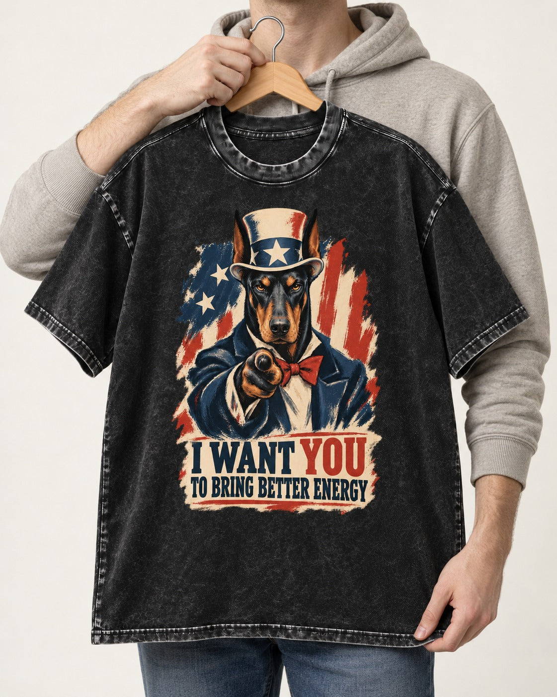 Doberman I Want You to Bring Better Energy Uncle Sam Graphic Washed Tee in Black, held up on a hanger