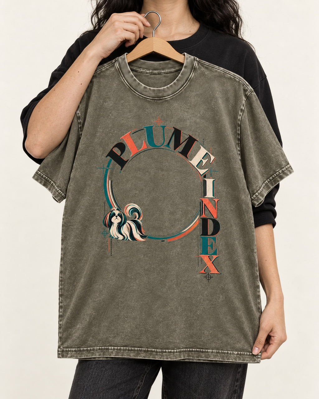 Shih Tzu Plume Index Circular Typography Graphic Washed Tee in Army Green, held up on a hanger