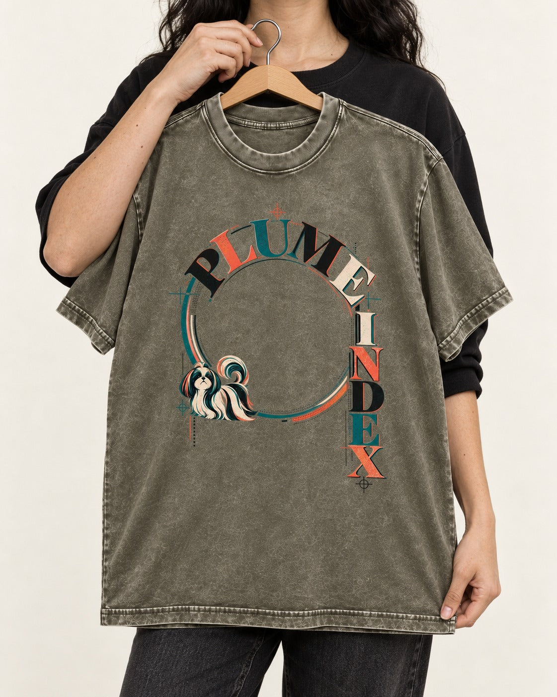 Shih Tzu Plume Index Circular Typography Graphic Washed Tee in Army Green, held up on a hanger