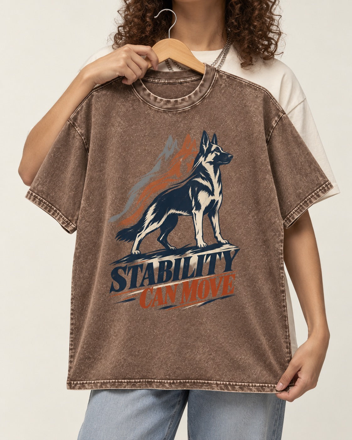 Stability Can Move German Shepherd Dog Washed Tee in Coffee, held up on a hanger