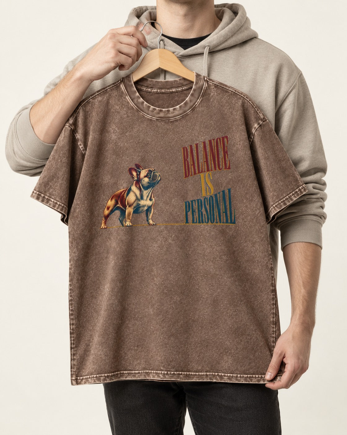 Frenchie Balance Is Personal Washed Tee in Coffee, held up on a hanger