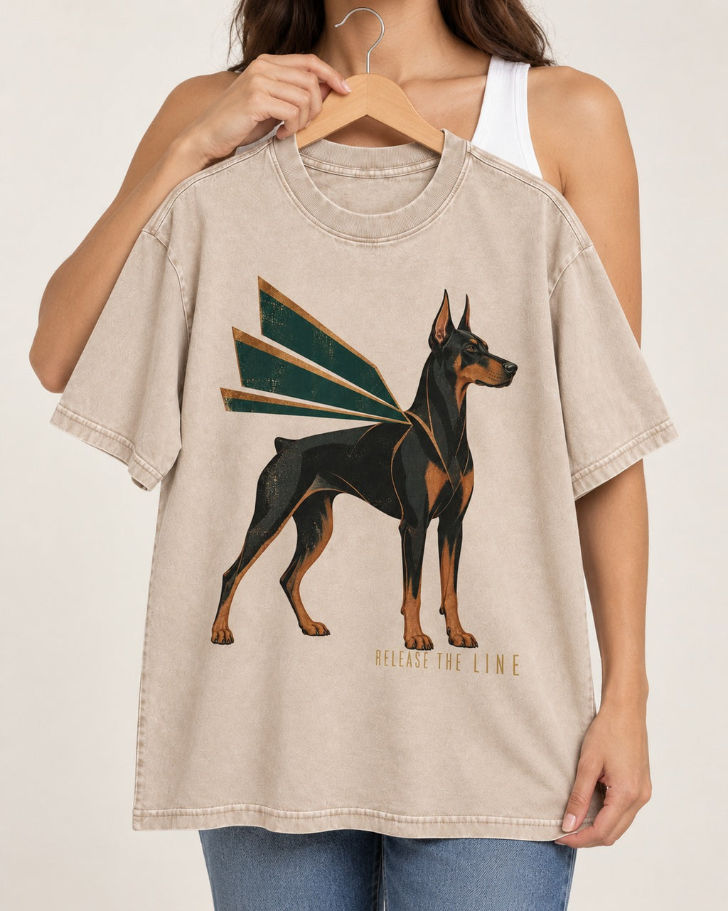 Release the Doberman Line Washed Tee in Apricot, held up on a hanger