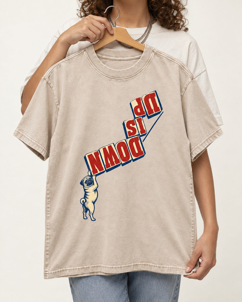 Down Is Up Pug Washed Tee in Apricot, held up on a hanger