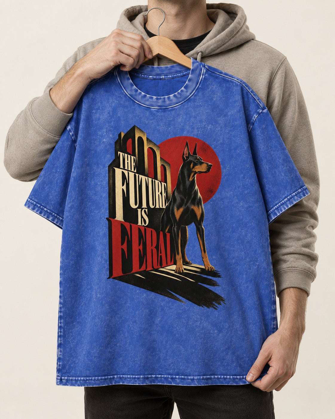 Doberman The Future Is Feral Art Deco Graphic Washed Tee in Royal Blue, held up on a hanger