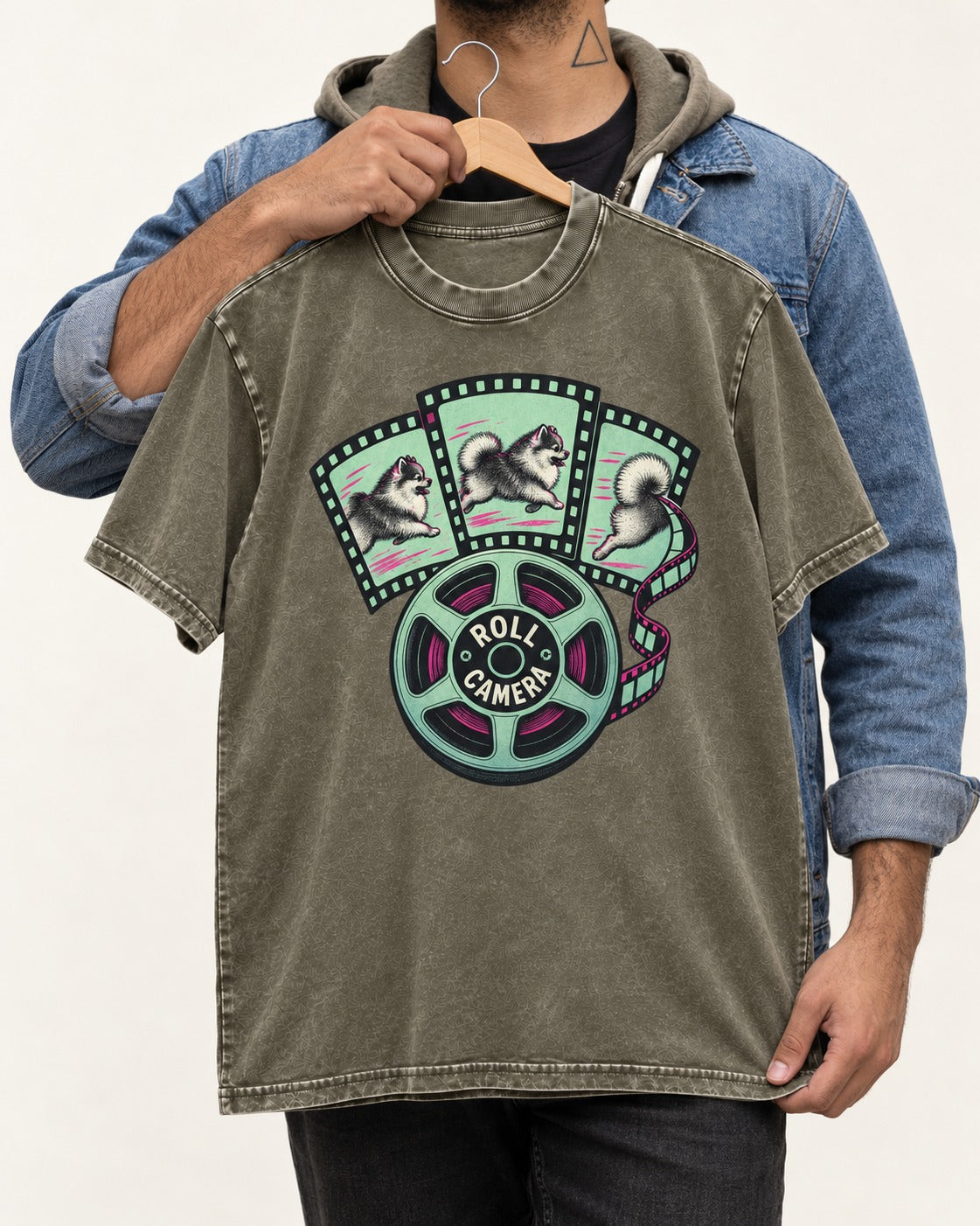 Pomeranian Roll Camera Film Reel Graphic Washed Tee in Army Green, held up on a hanger