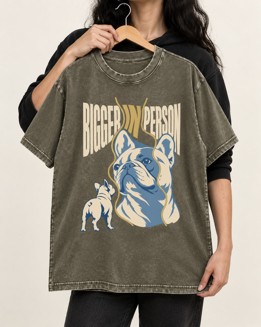 Frenchie Bigger in Person Mirror Graphic Washed Tee in Army Green, held up on a hanger