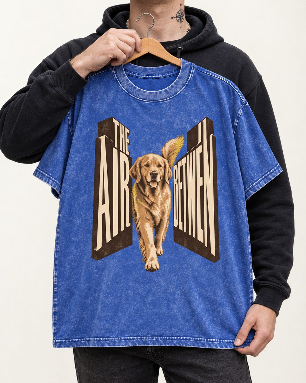 The Air Between Dimensional Golden Retriever Graphic Washed Tee in Royal Blue, held up on a hanger