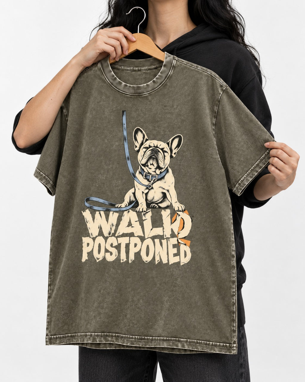 Frenchie Walk Postponed Leash Graphic Washed Tee in Army Green, held up on a hanger
