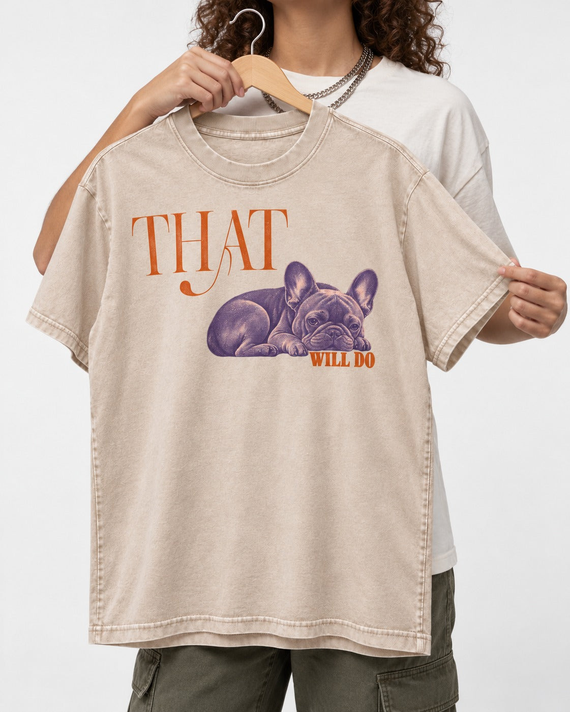 Frenchie That Will Do Resting Graphic Washed Tee in Apricot, held up on a hanger
