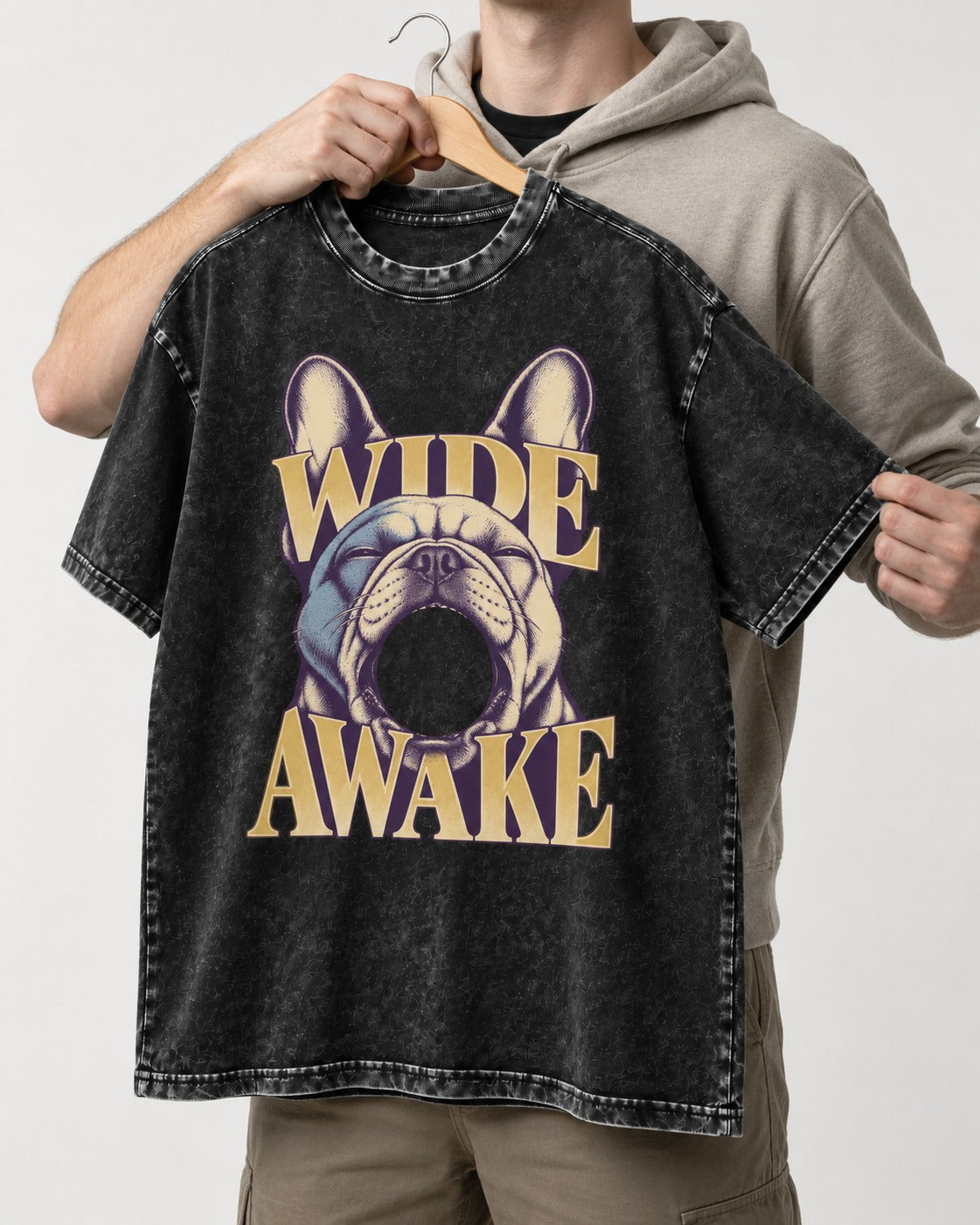 Frenchie Wide Awake Yawn Graphic Washed Tee in Black, held up on a hanger