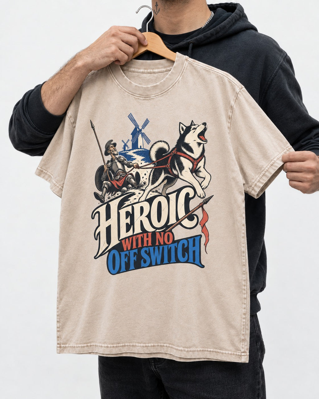 Husky Heroic with No Off Switch Don Quixote Graphic Washed Tee in Apricot, held up on a hanger
