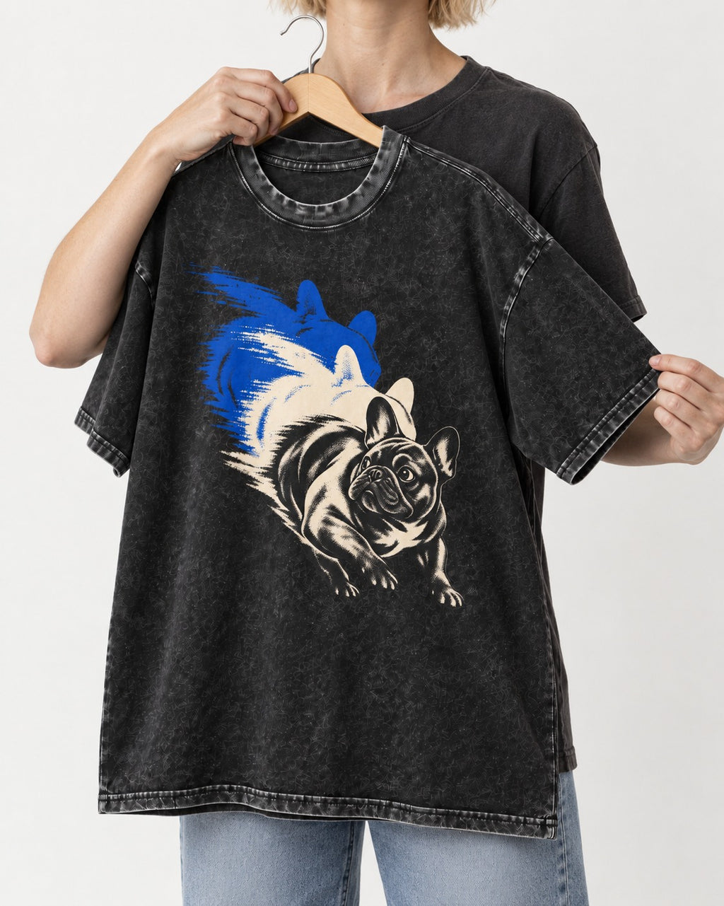 Frenchie Blue Brush Zoomie Graphic Washed Tee in Black, held up on a hanger