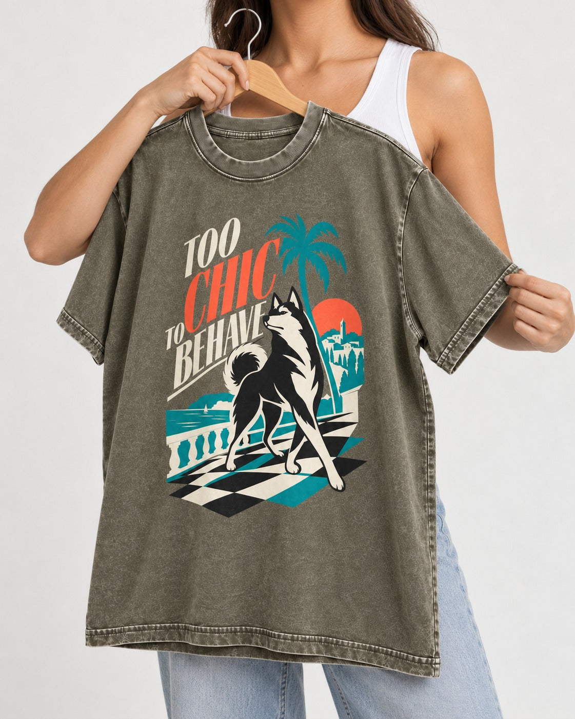 Husky Too Chic to Behave Riviera Graphic Washed Tee in Army Green, held up on a hanger