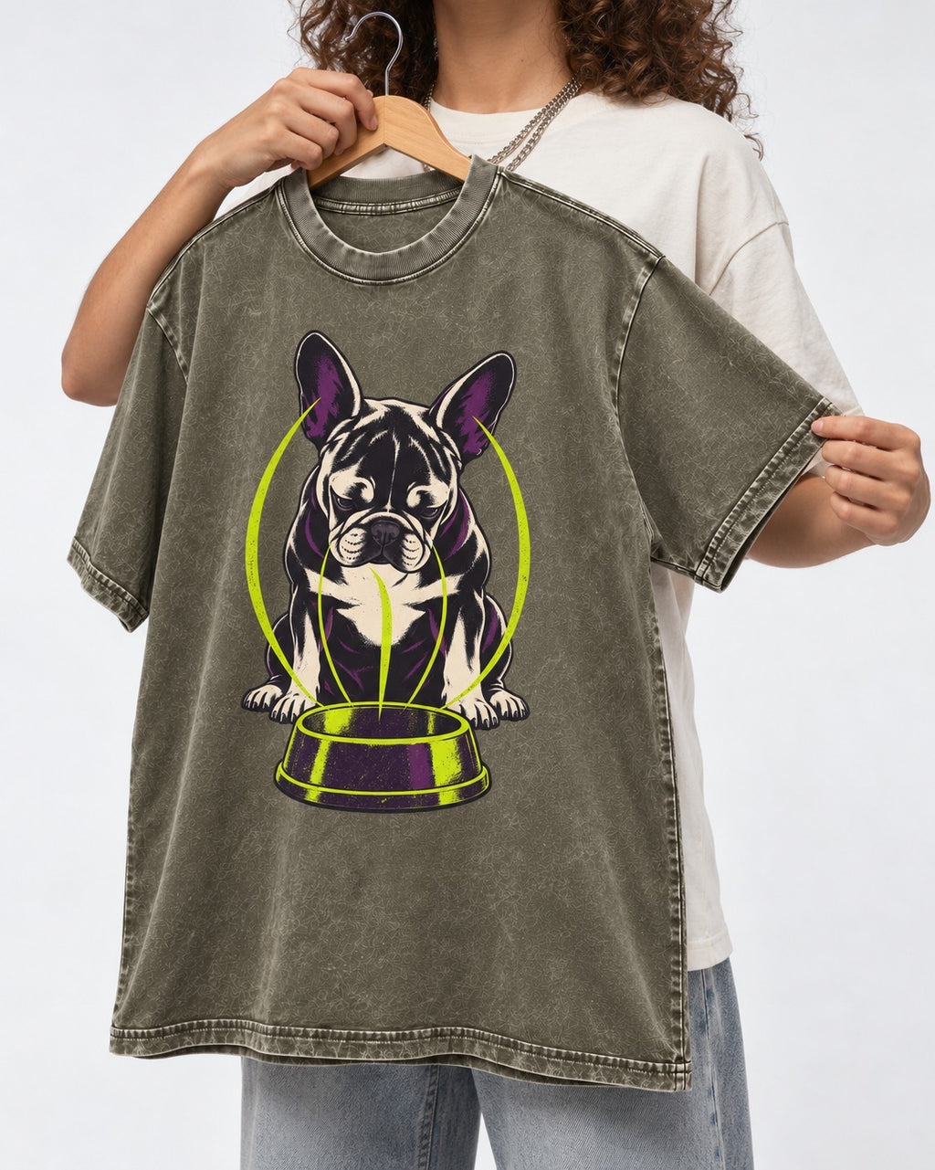 Frenchie Bowl Gravity Graphic Washed Tee in Army Green, held up on a hanger