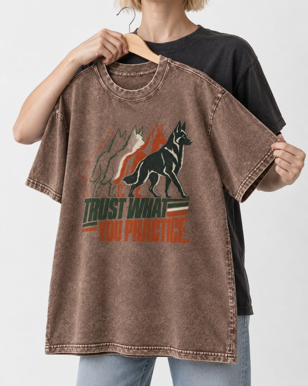 Trust What You Practice German Shepherd Dog Washed Tee in Coffee, held up on a hanger