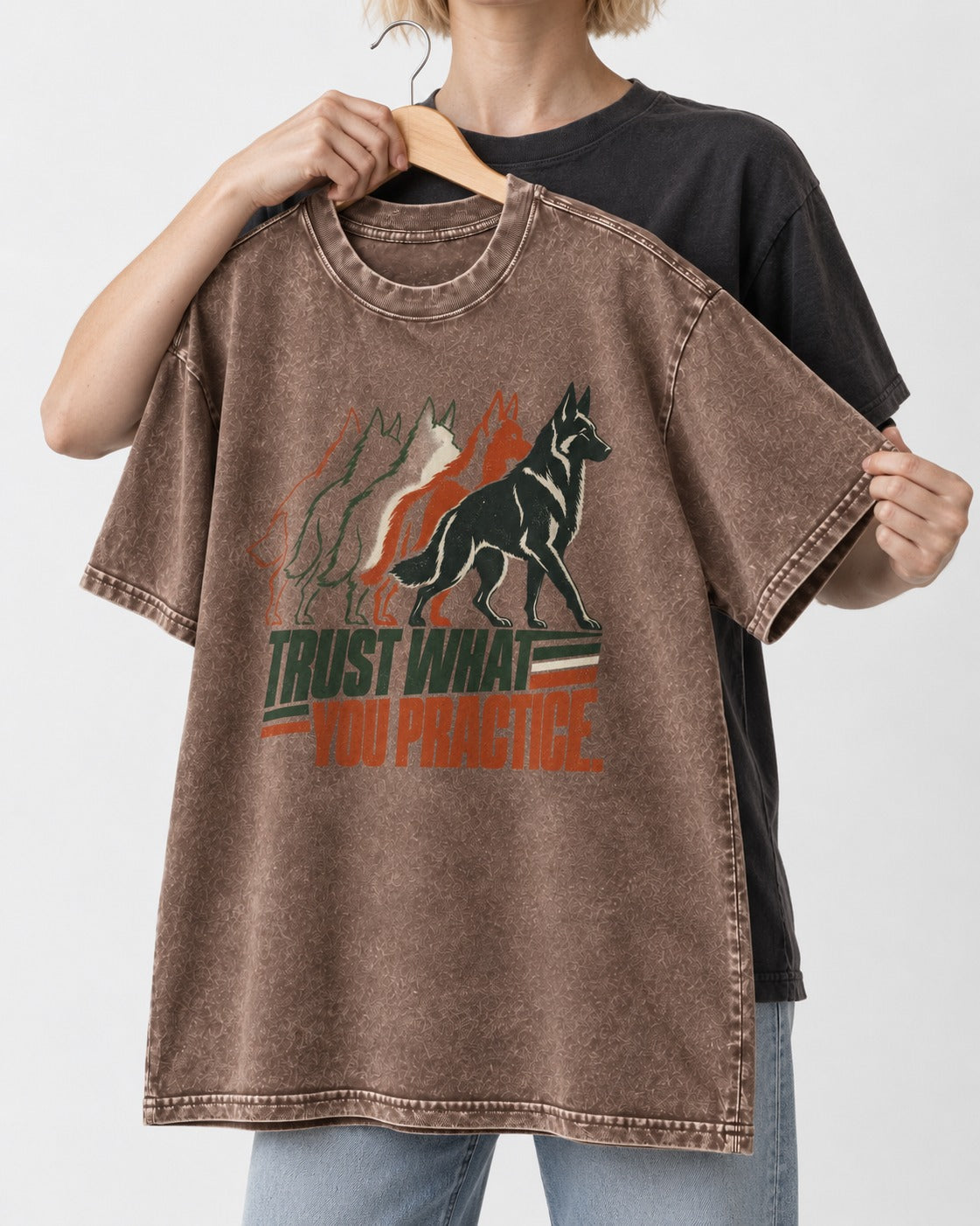 Trust What You Practice German Shepherd Dog Washed Tee in Coffee, held up on a hanger