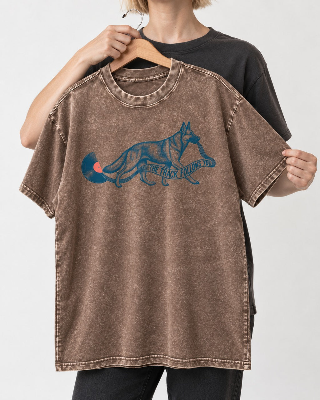 German Shepherd Dog The Track Follows You Washed Tee in Coffee, held up on a hanger