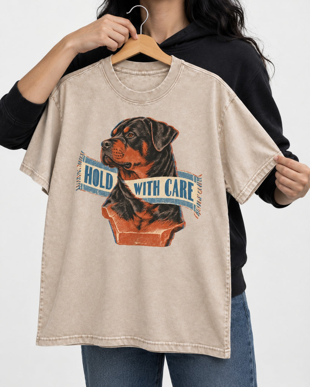 Rottweiler Hold with Care Washed Tee in Apricot, held up on a hanger