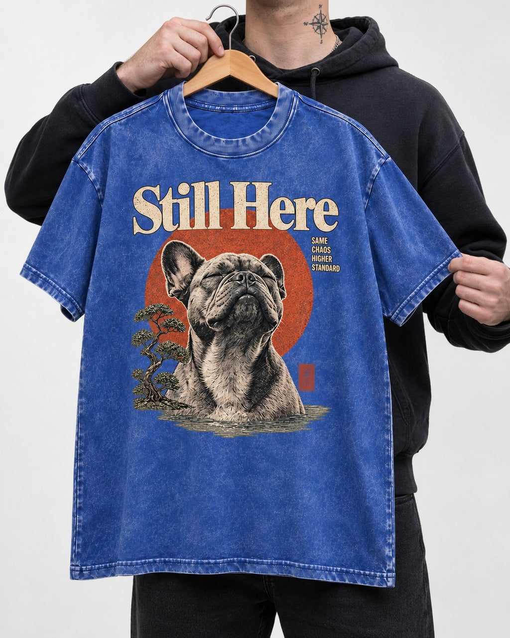 Frenchie Still Here Bonsai Portrait Graphic Washed Tee in Royal Blue, held up on a hanger