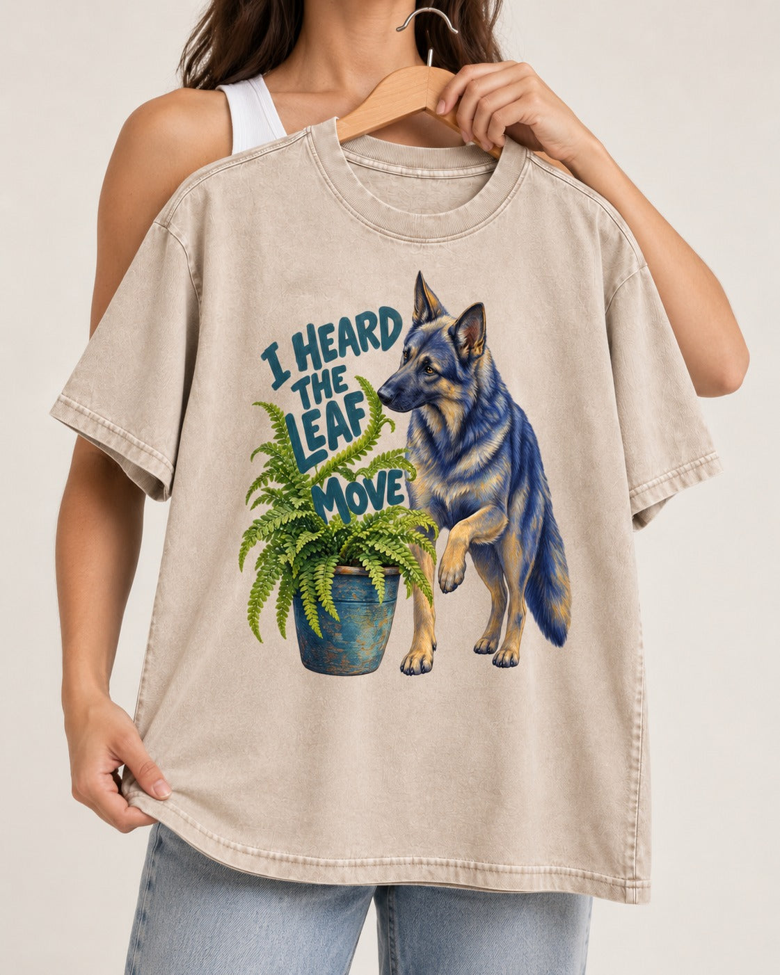 German Shepherd Dog Heard the Leaf Move Washed Tee in Apricot, held up on a hanger