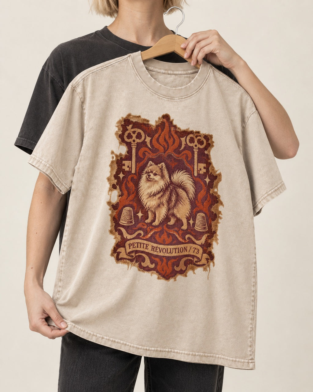 Pomeranian Petite Revolution Ornate Key Emblem Graphic Washed Tee in Apricot, held up on a hanger