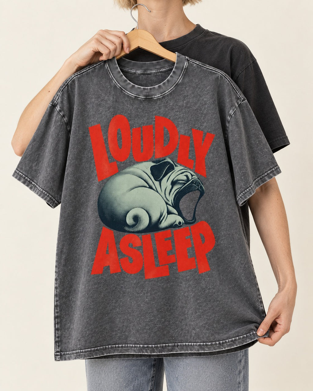 Pug Loudly Asleep Curled Yawn Graphic Washed Tee in Gray, held up on a hanger