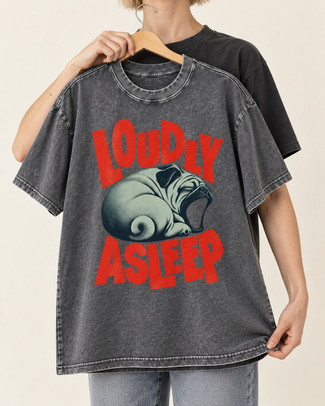 Pug Loudly Asleep Curled Yawn Graphic Washed Tee in Gray, held up on a hanger