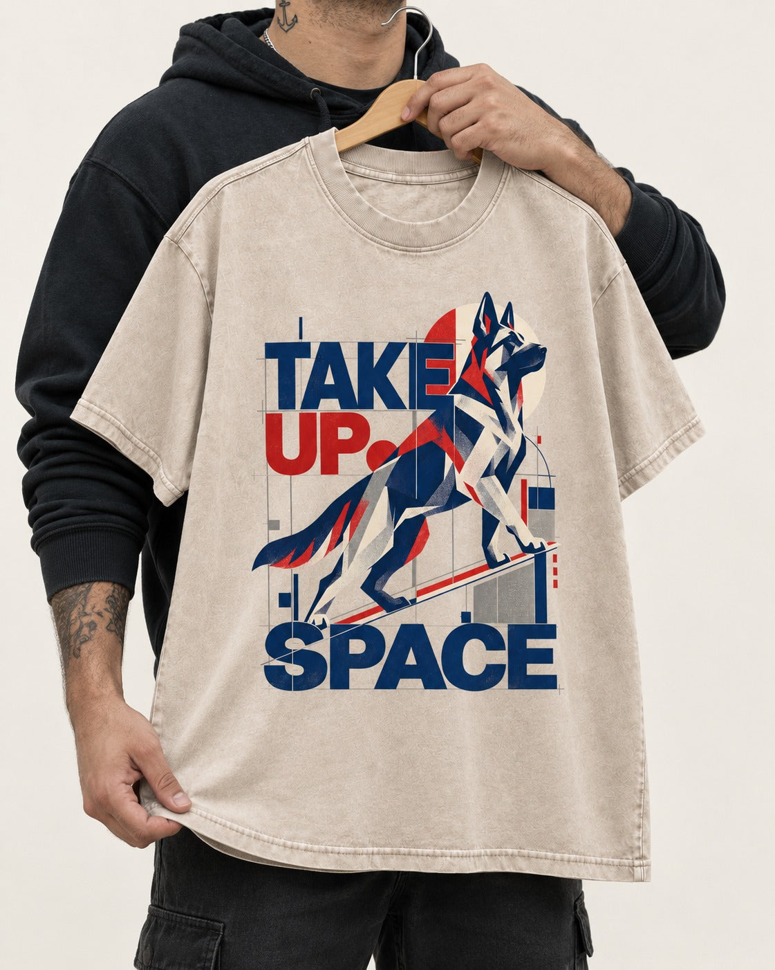 Take Up Space German Shepherd Dog Washed Tee in Apricot, held up on a hanger