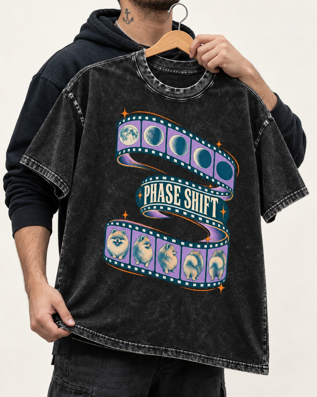 Pomeranian Phase Shift Filmstrip Graphic Washed Tee in Black, held up on a hanger