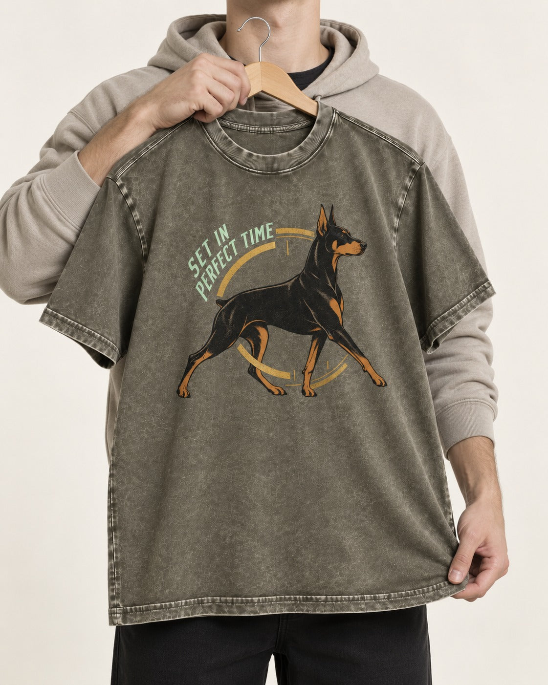 Doberman Set in Perfect Time Clock Stride Graphic Washed Tee in Army Green, held up on a hanger