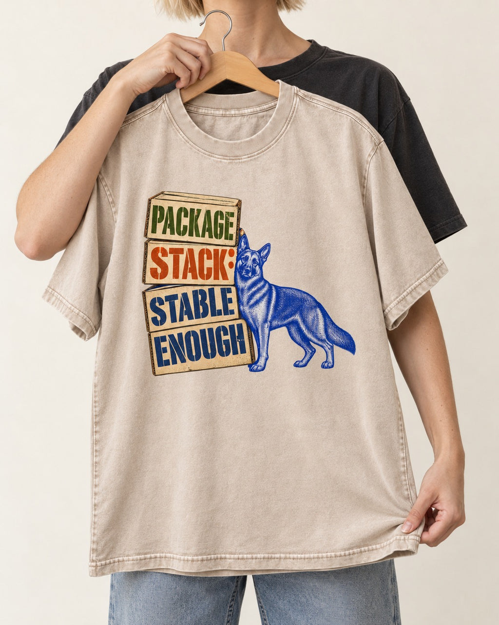 Package Stack Stable Enough German Shepherd Dog Washed Tee in Apricot, held up on a hanger