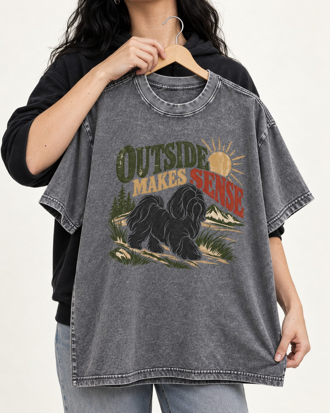 Shih Tzu Outside Makes Sense Mountain Trail Graphic Washed Tee in Gray, held up on a hanger