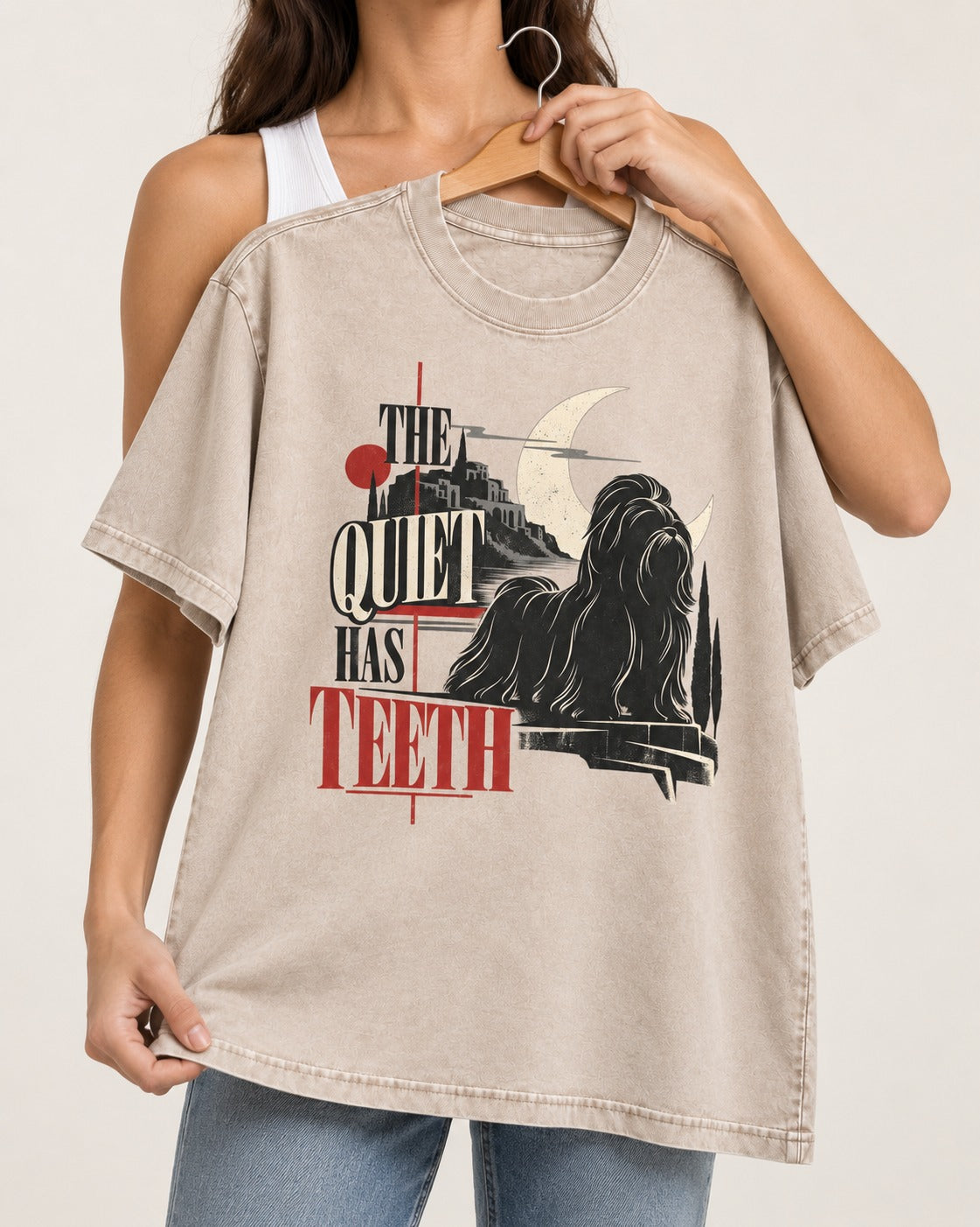 The Quiet Shih Tzu Has Teeth Washed Tee in Apricot, held up on a hanger