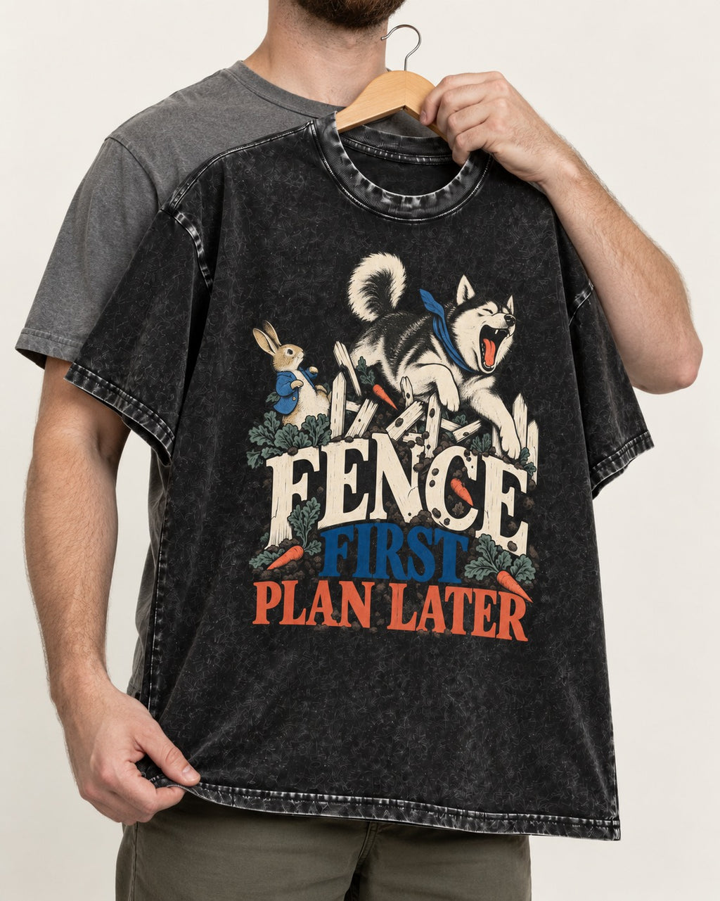 Husky Fence First Plan Later Garden Escape Graphic Washed Tee in Black, held up on a hanger