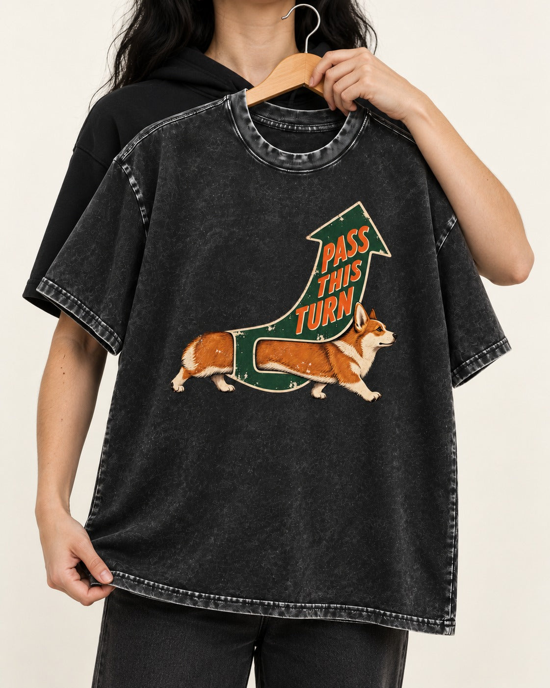Corgi Pass This Turn Washed Tee in Black, held up on a hanger