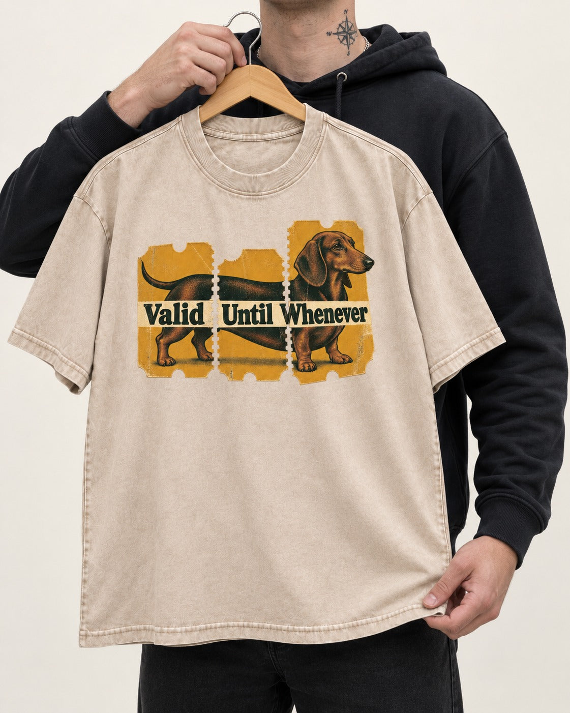 Dachshund Valid Until Whenever Washed Tee in Apricot, held up on a hanger