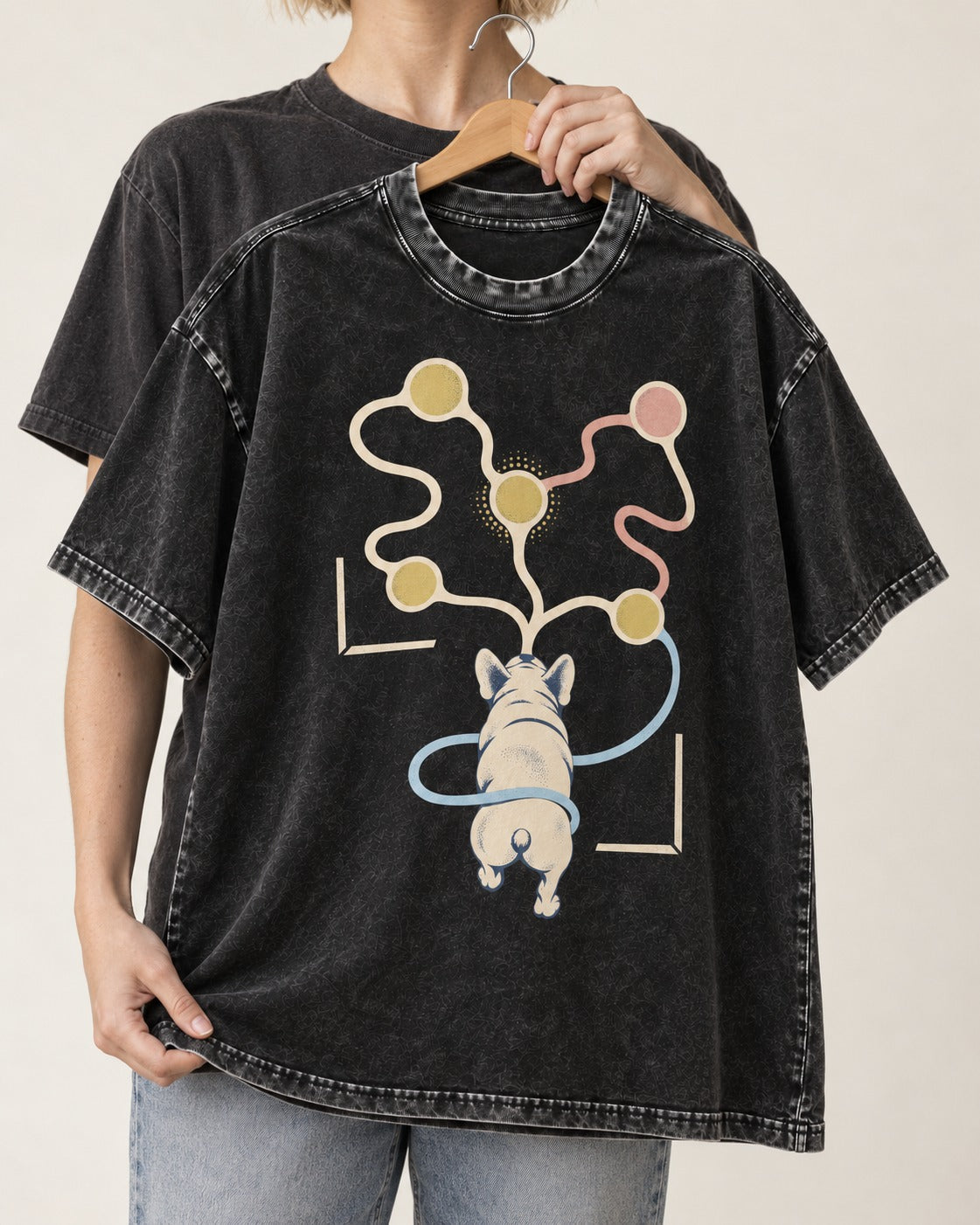 Frenchie Scent Circuit Rear View Graphic Washed Tee in Black, held up on a hanger