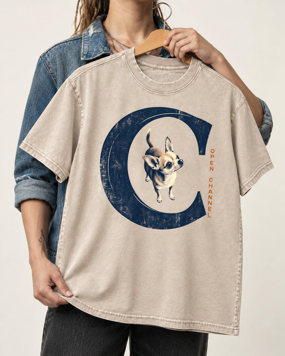 Chihuahua Open Channel Washed Tee in Apricot, held up on a hanger