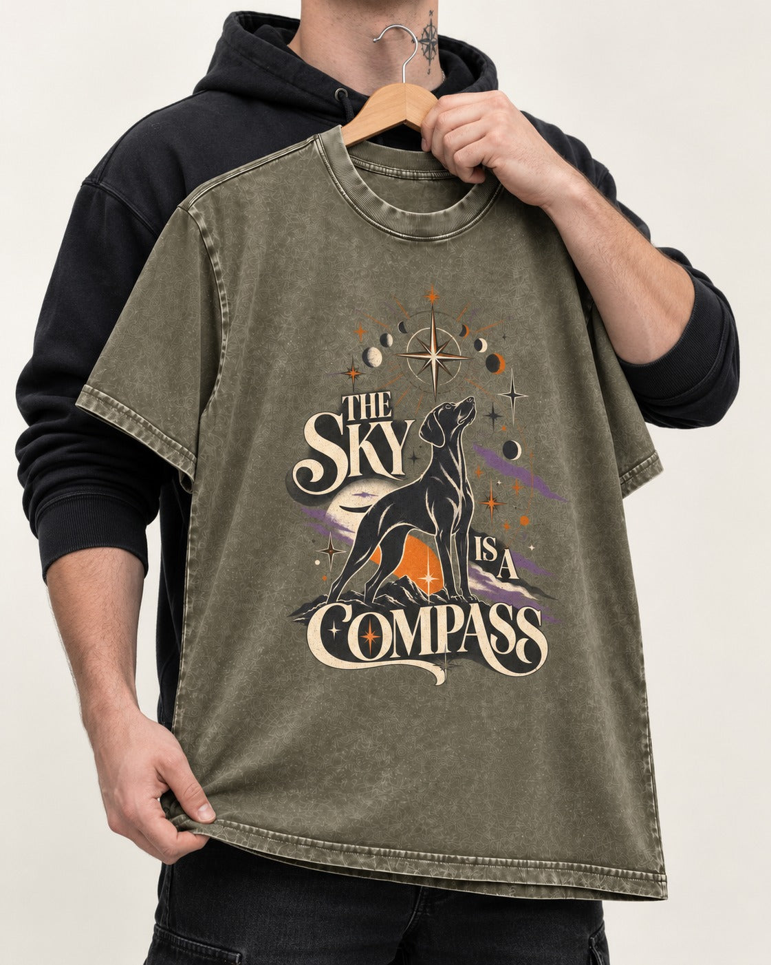 The Sky Is a Compass Celestial German Shorthaired Pointer Graphic Washed Tee in Army Green, held up on a hanger